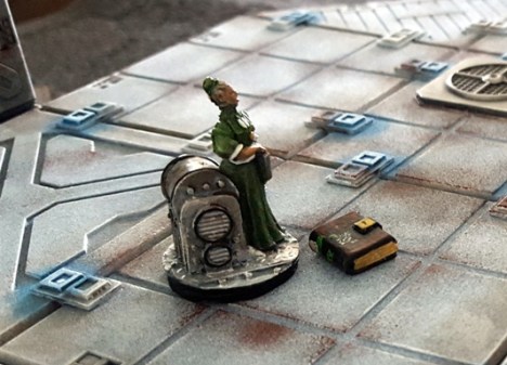 One of the scientists deactivates her fridge freezer sized cloaking device to examine a book. 